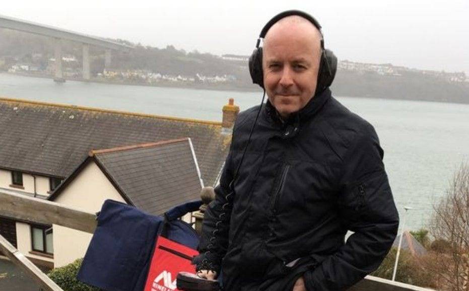 mike smith wearing headphones and a jacket