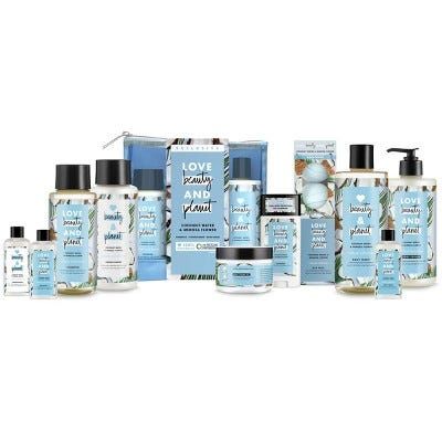 blue, black and white bottles and jars of love beauty and planet skincare and hair products on a white background