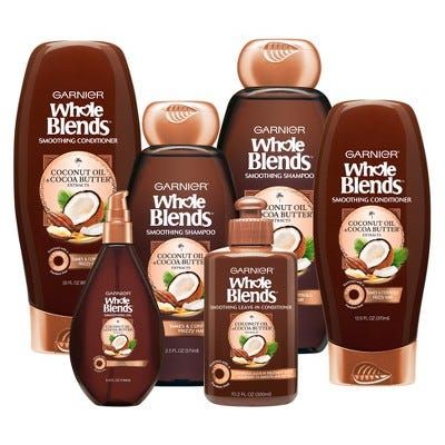 brown garnier whole blends haircare products on a white background