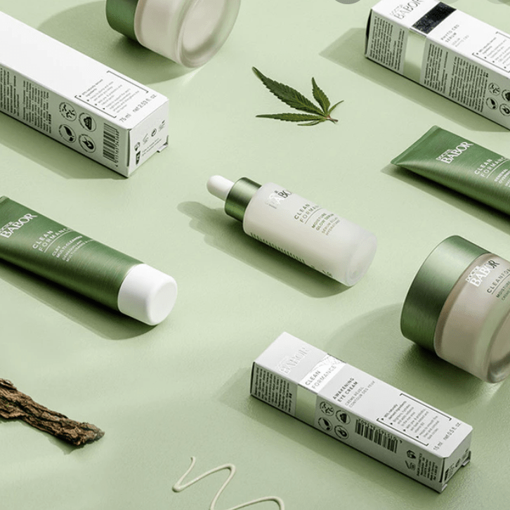 green and white tubes, bottles and jars of babor skincare products on a light green background